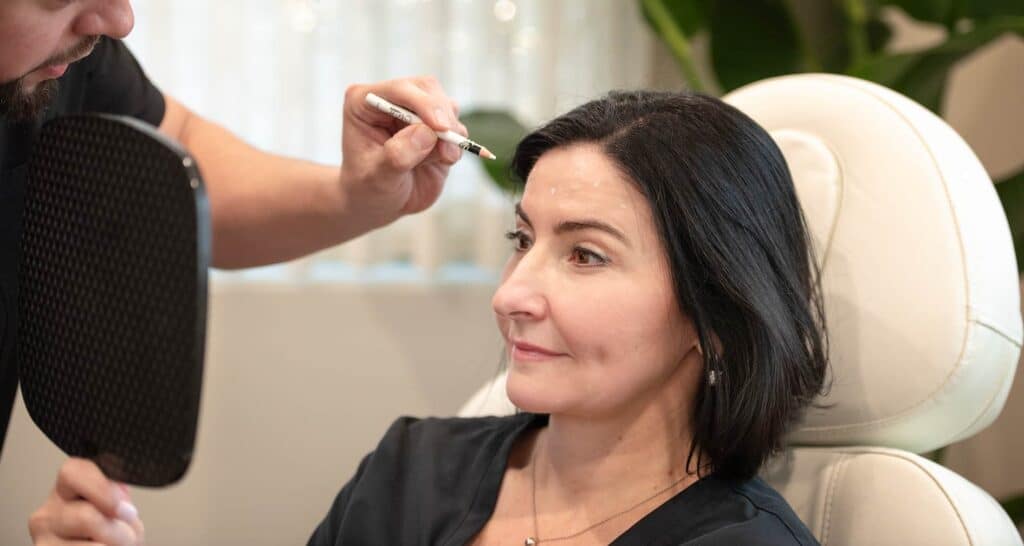 Woman being marked for Jeuveau injections in a med spa